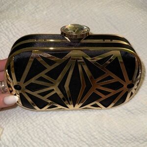 A charming Charlie black and gold crystal clutch